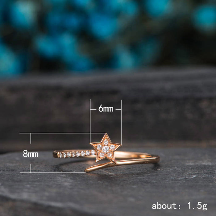 Anillo de mujer con forma de estrella de circonita bañada en oro rosa y diseño de estrella fugaz