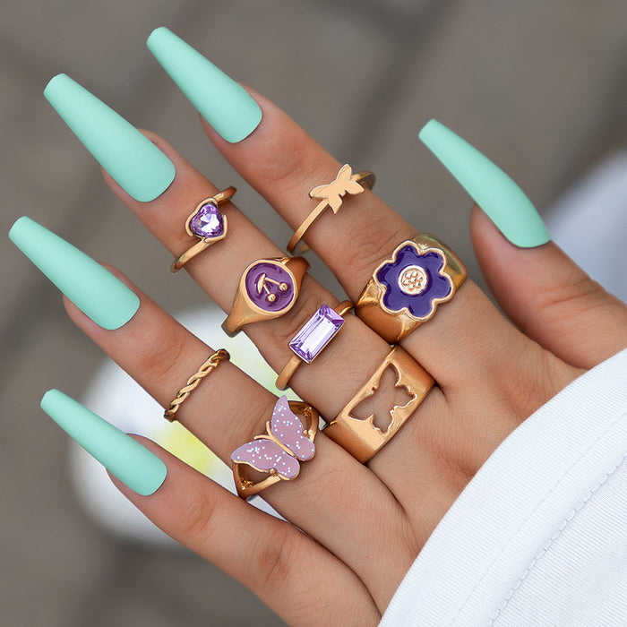 Conjunto de anillos de mariposa violeta con joyas dulces, conjunto de ocho piezas con incrustaciones de diamantes en forma de corazón y flores con gotas de aceite