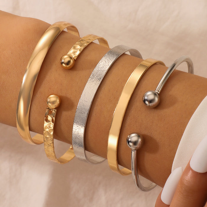 Conjunto de pulseras ajustables de plata y oro: colección de cinco piezas con cuentas redondas lisas