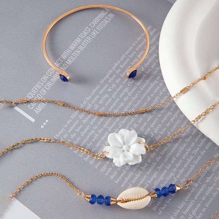 Conjunto de pulseras de conchas y estrellas de mar: cuatro piezas de joyería de aleación de oro para mujer