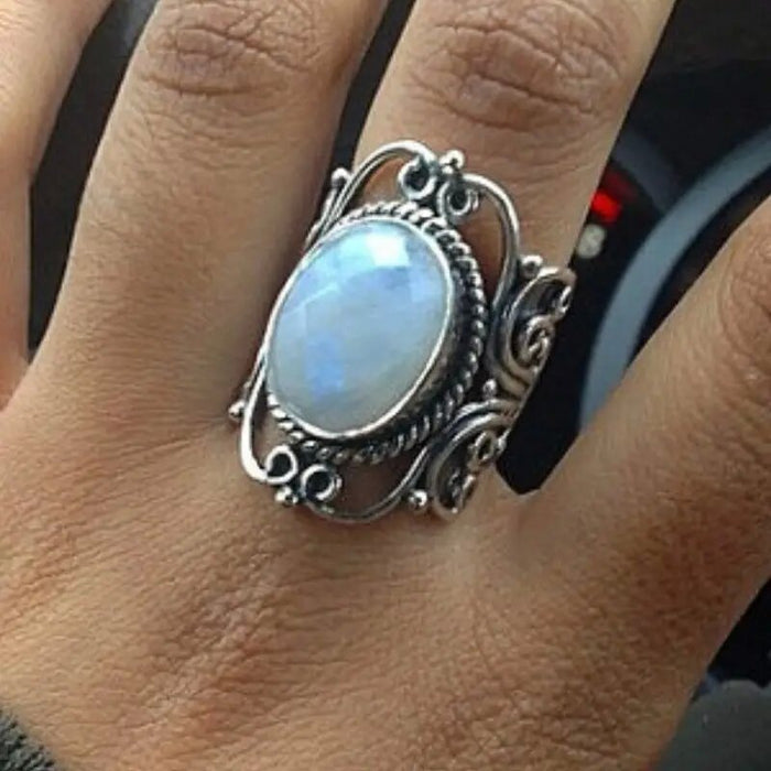 Ring with geometric hollow carvings inlaid with imitation moonstone