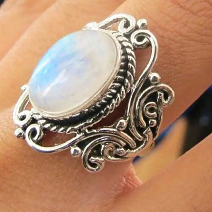 Ring with geometric hollow carvings inlaid with imitation moonstone