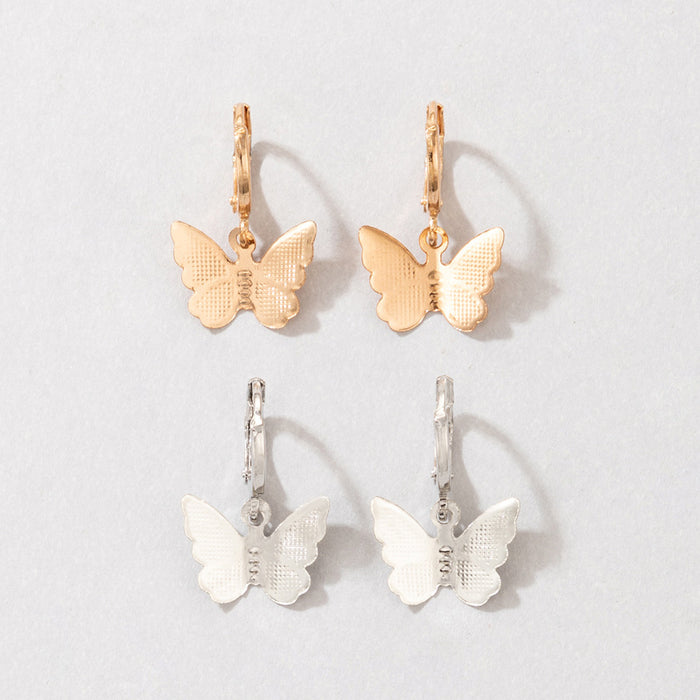 Conjunto de pendientes de mariposa con contraste de oro y plata