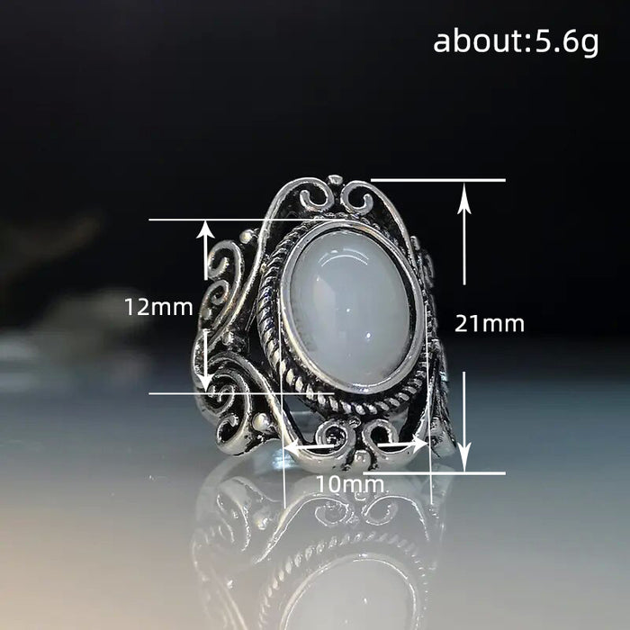 Ring with geometric hollow carvings inlaid with imitation moonstone