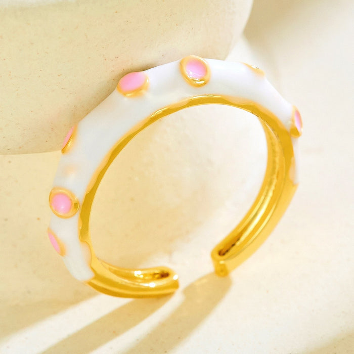 Wholesale gold-plated copper rings with colored droplets and geometric open designs.