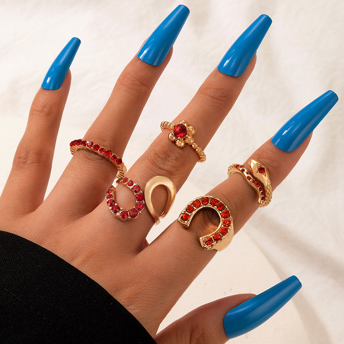 Juego de 5 anillos rojos con forma de serpiente y letras irregulares