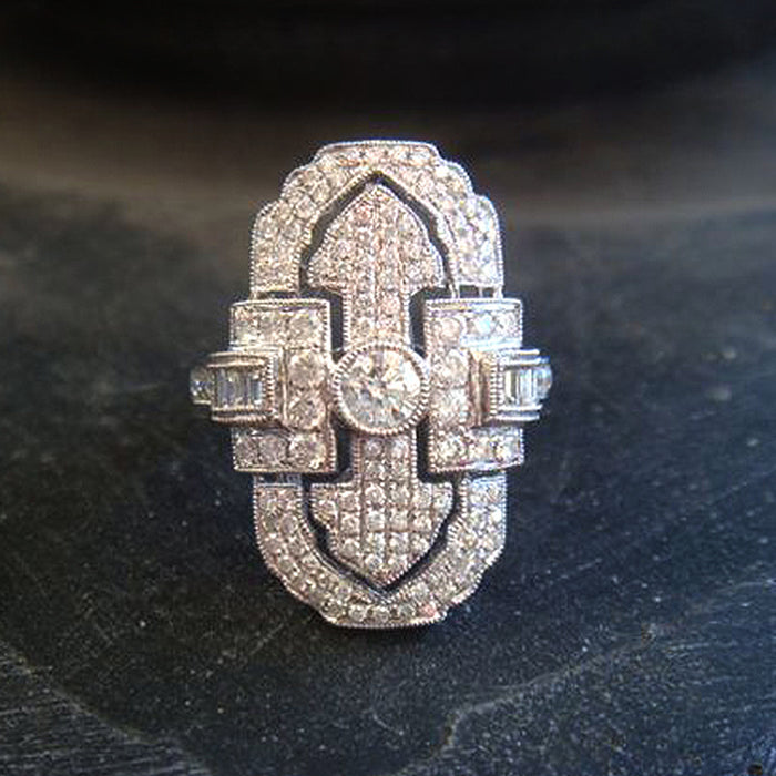 Green gemstone ring with multi-layer diamond design