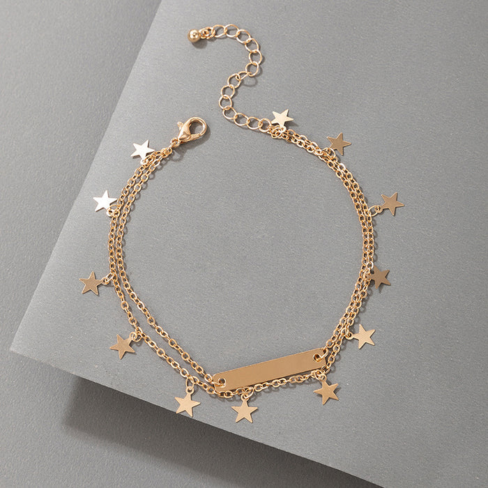 Tobillero minimalista dorado con borlas y estrellas para mujer