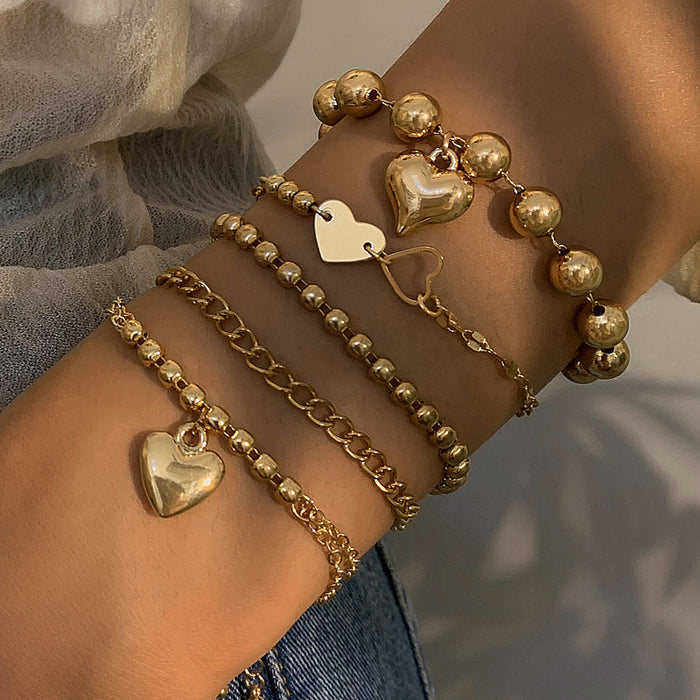 Elegante conjunto de pulseras de metal multicapa con forma de corazón: diseño único de cadena geométrica