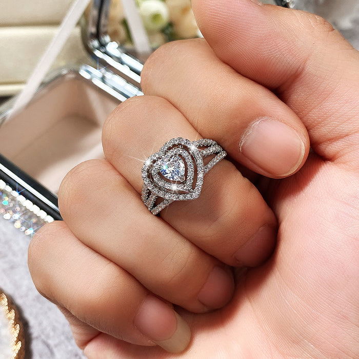 Anillo de compromiso con forma de corazón y microincrustaciones de circonitas de doble fila