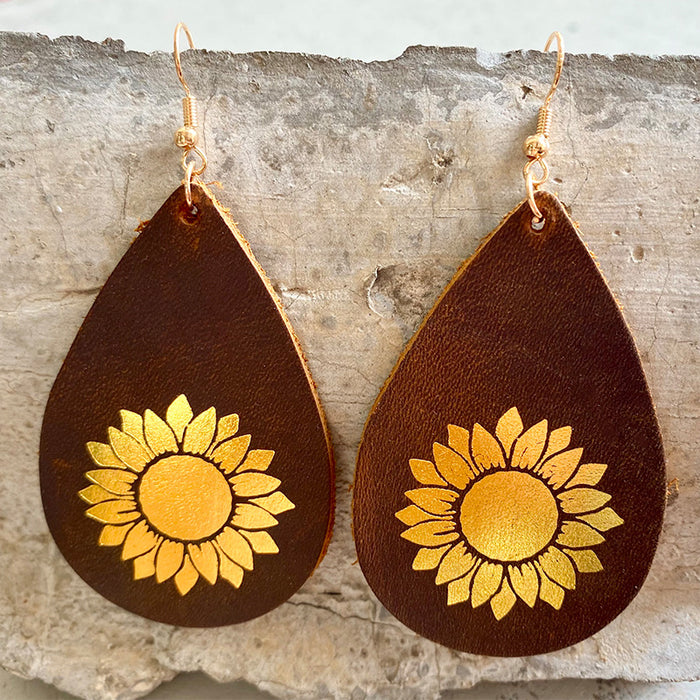 Pendientes de lágrima de cuero genuino con lámina de oro y diseño de girasol y cruz