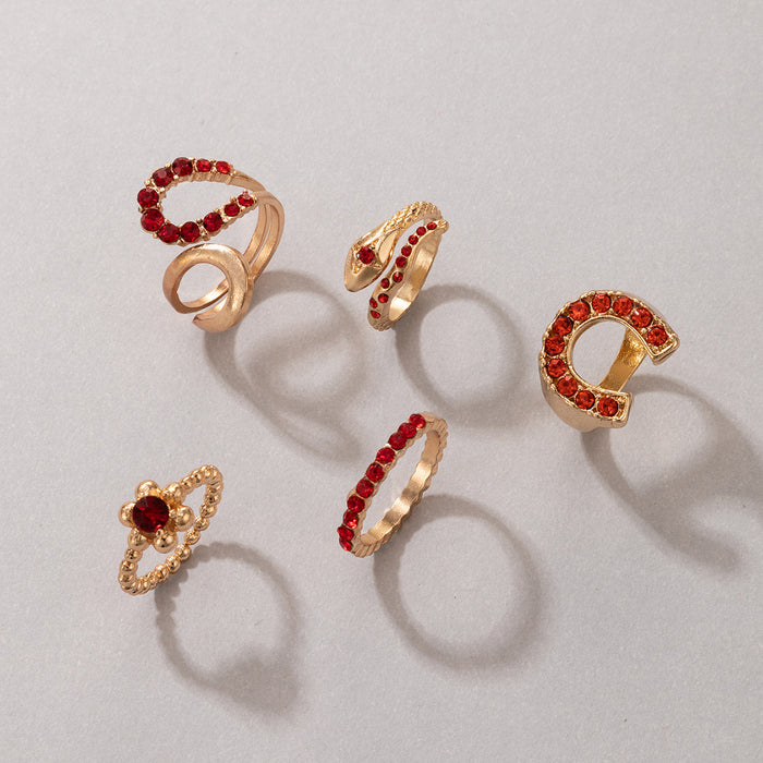 Juego de 5 anillos rojos con forma de serpiente y letras irregulares