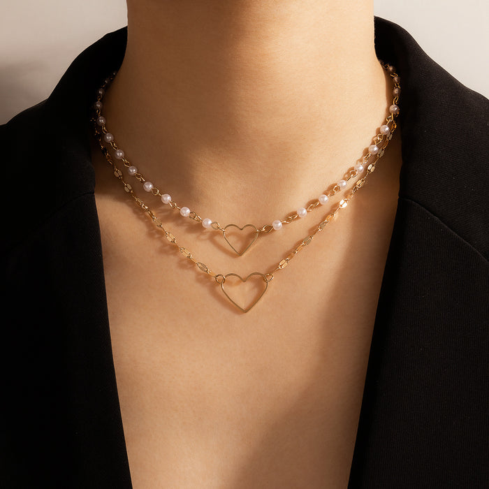 Collar con colgante de corazón de dos capas y perlas: joyería moderna con forma de corazón