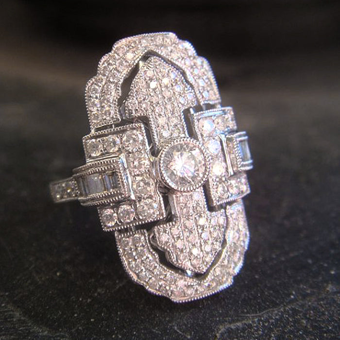 Green gemstone ring with multi-layer diamond design