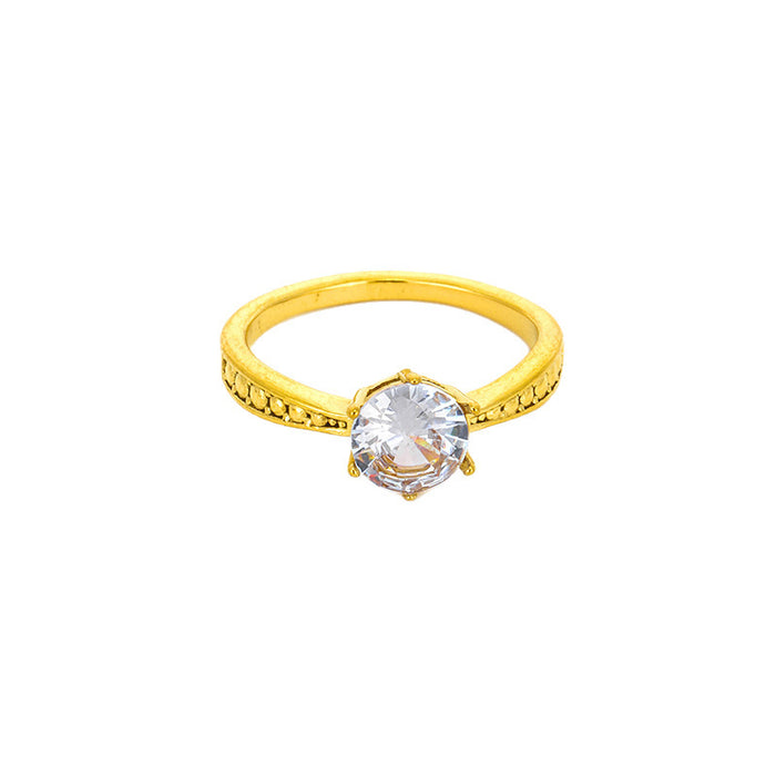 Wholesale 18K gold-plated titanium steel patterned rings set with a single zircon.