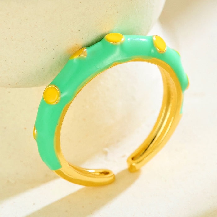 Wholesale gold-plated copper rings with colored droplets and geometric open designs.
