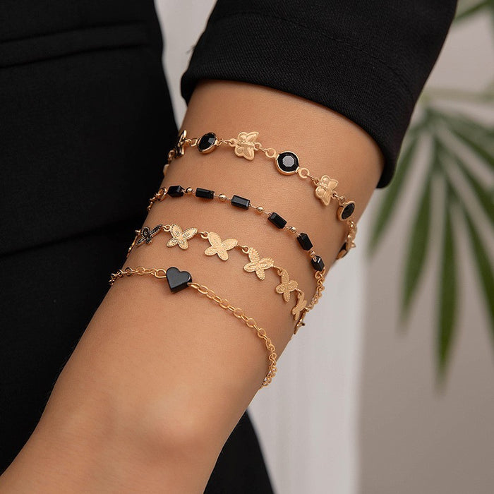 Conjunto de pulsera con colgante de trébol de cuatro hojas negro de estilo bohemio europeo: joyería con cadena de metal geométrica