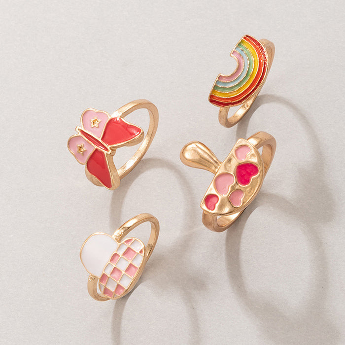 Lindo juego de anillos de 4 piezas con forma de corazón de arcoíris y mariposa rosa