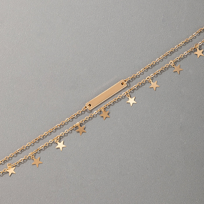 Tobillero minimalista dorado con borlas y estrellas para mujer