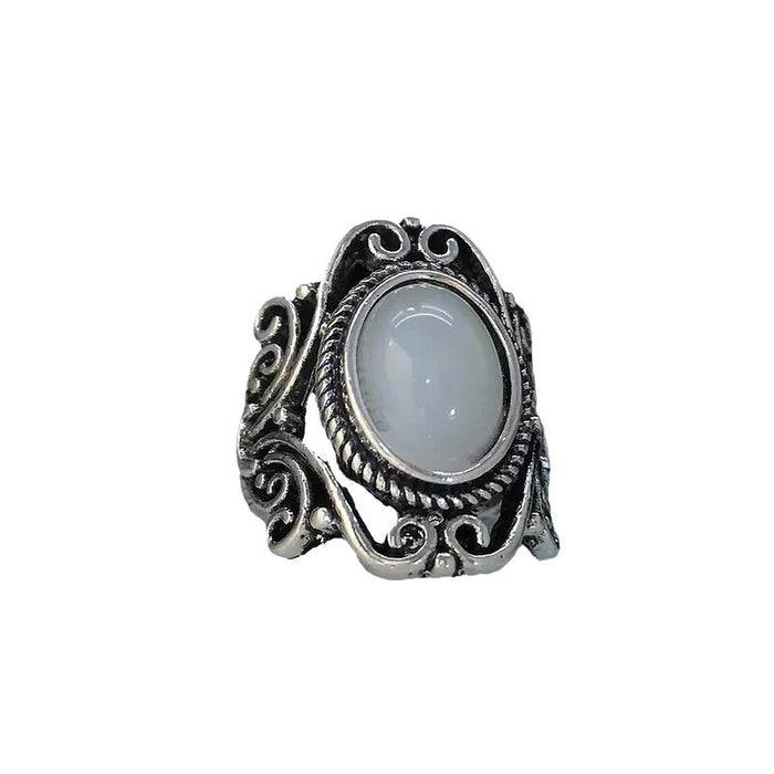 Ring with geometric hollow carvings inlaid with imitation moonstone