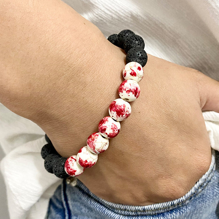 Pulsera de calavera de piedra de lava que brilla en la oscuridad con manchas de sangre para Halloween