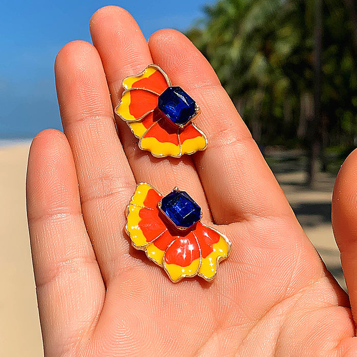 Pendientes geométricos con forma de gota de aceite en color rojo