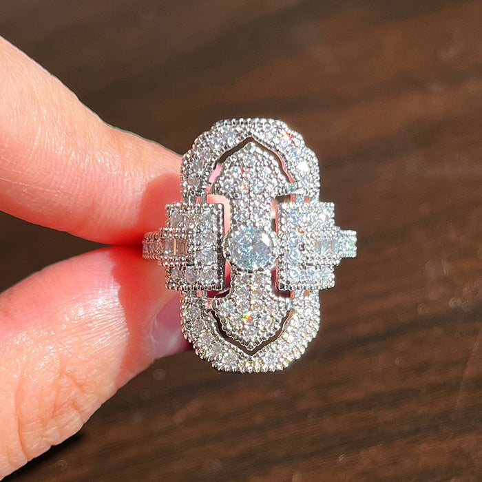 Green gemstone ring with multi-layer diamond design