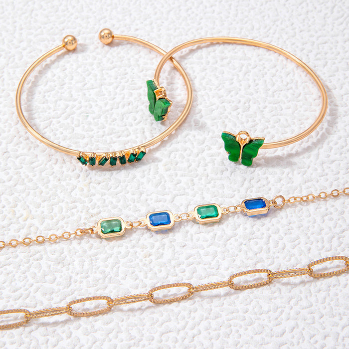 Conjunto de pulseras de piedras preciosas verdes con puño abierto de mariposa: elegante conjunto de cuatro piezas de joyería