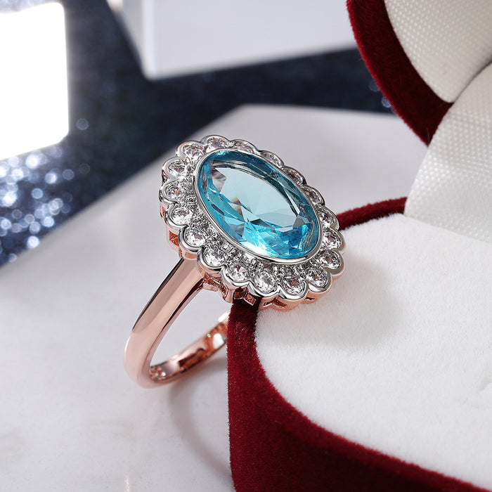 Anillo de mujer con circonita ovalada azul marino con incrustaciones de dos tonos bañado en cobre