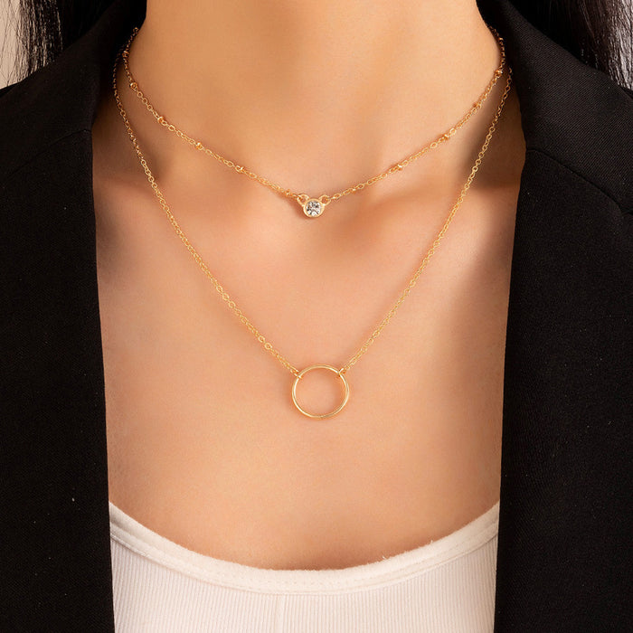 Collar de doble capa con anillo de diamantes y diseño geométrico hueco