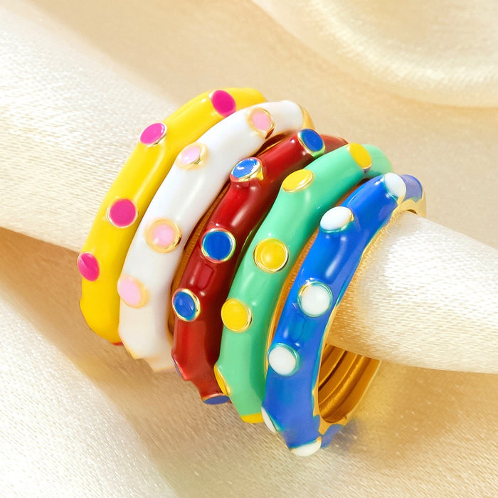 Wholesale gold-plated copper rings with colored droplets and geometric open designs.