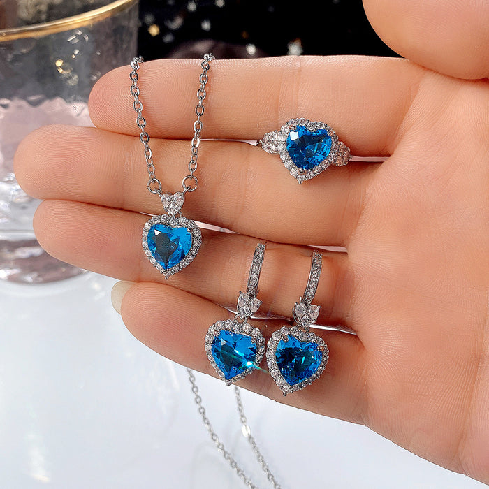 Conjunto de anillo y pendientes con forma de corazón de océano y circonita azul topacio