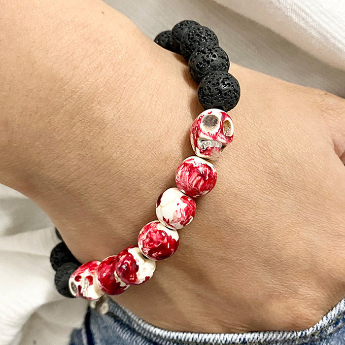 Pulsera de calavera de piedra de lava que brilla en la oscuridad con manchas de sangre para Halloween