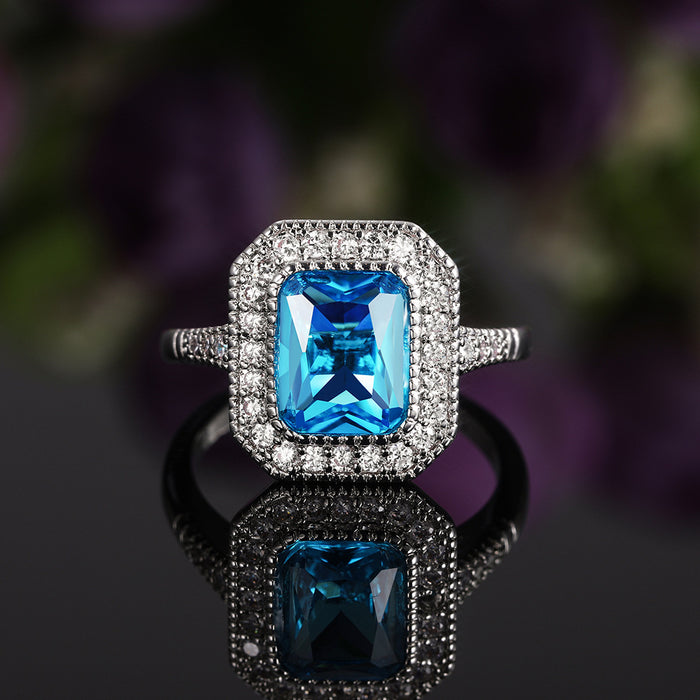 Anillo de mujer con circonita azul marino bañado en cobre y diseño de diamantes completos