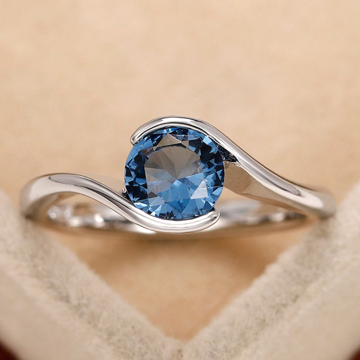 Anillo de mujer sencillo con brazo torcido, diamante redondo azul, circonita y topacio