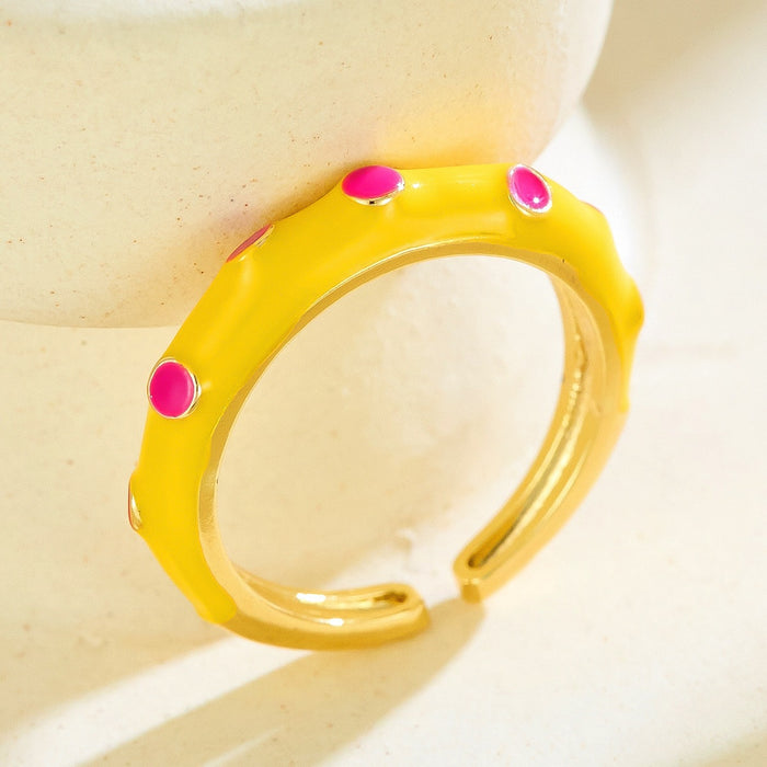 Wholesale gold-plated copper rings with colored droplets and geometric open designs.