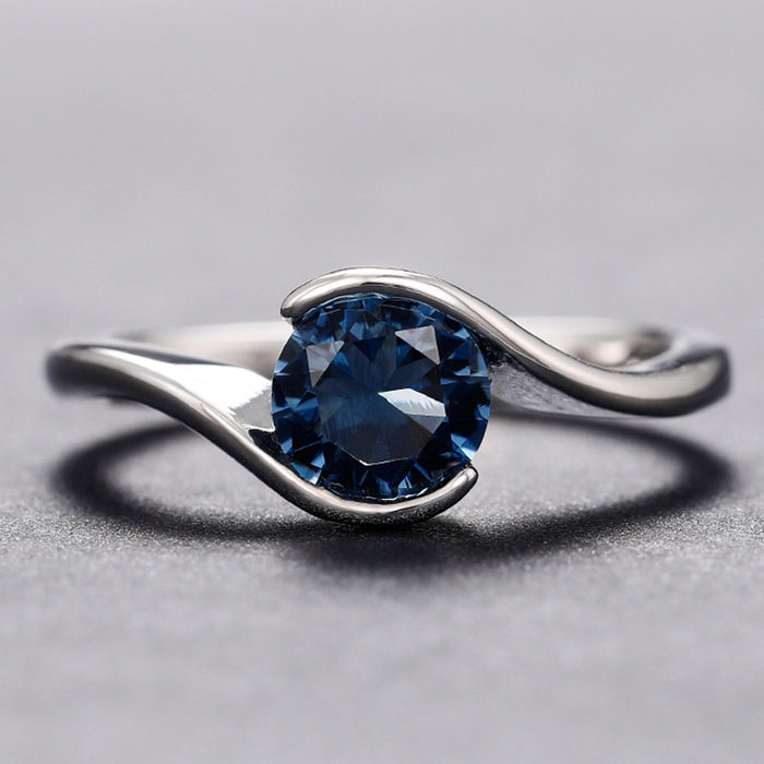 Anillo de mujer sencillo con brazo torcido, diamante redondo azul, circonita y topacio