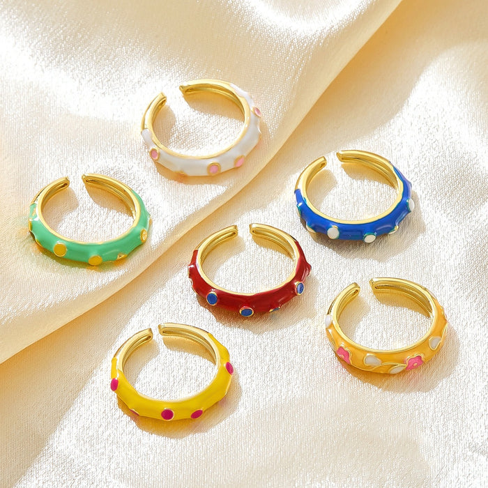 Wholesale gold-plated copper rings with colored droplets and geometric open designs.
